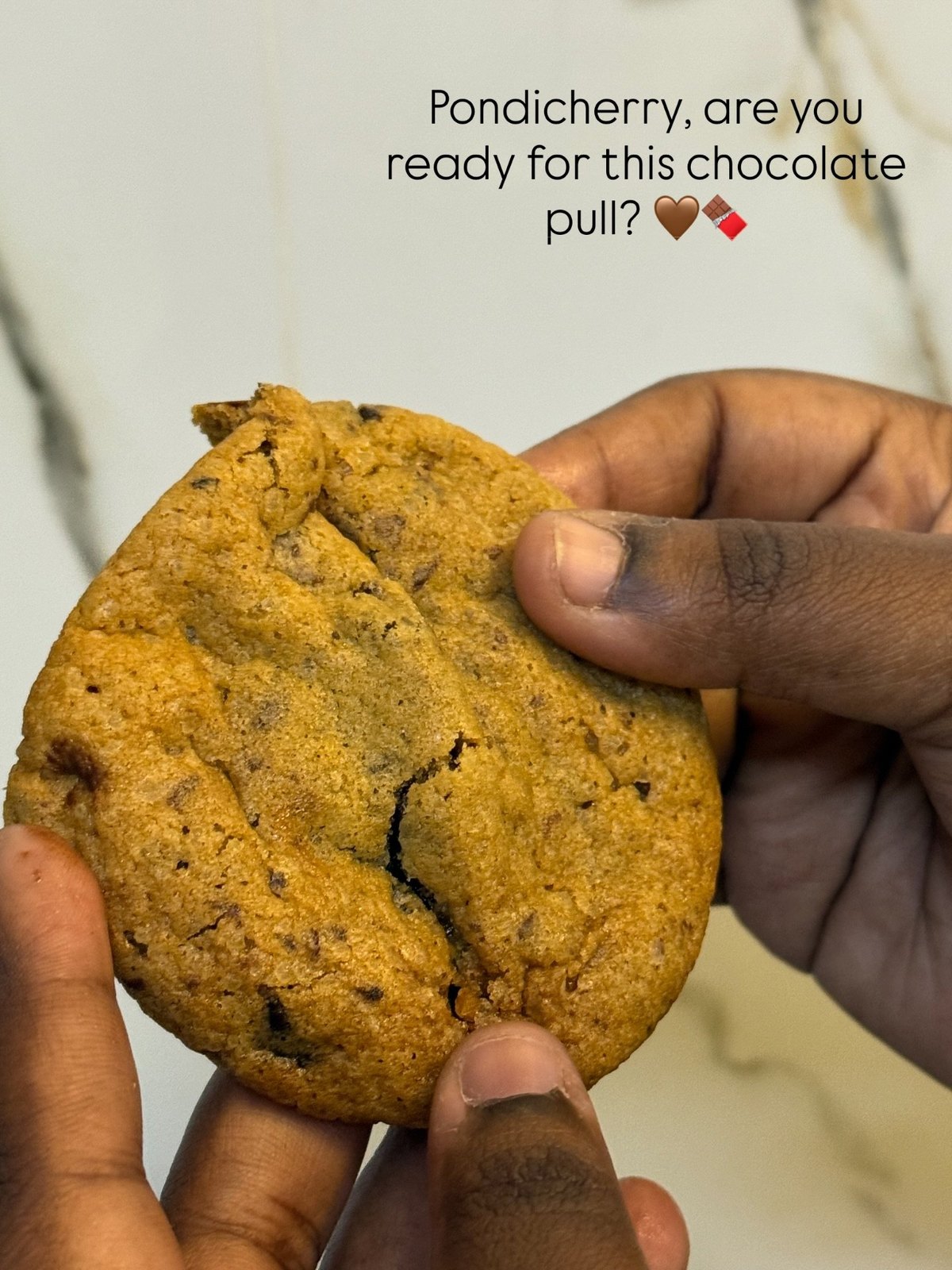 Cookie pulled apart with melted chocolate