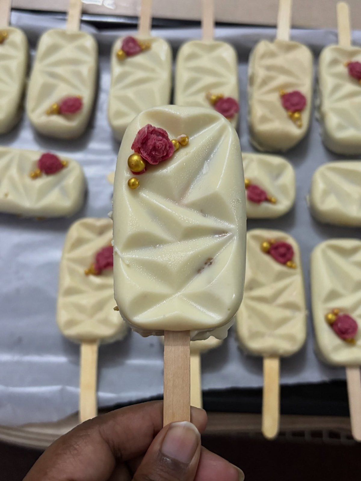 White chocolate cakesicles with dried roses